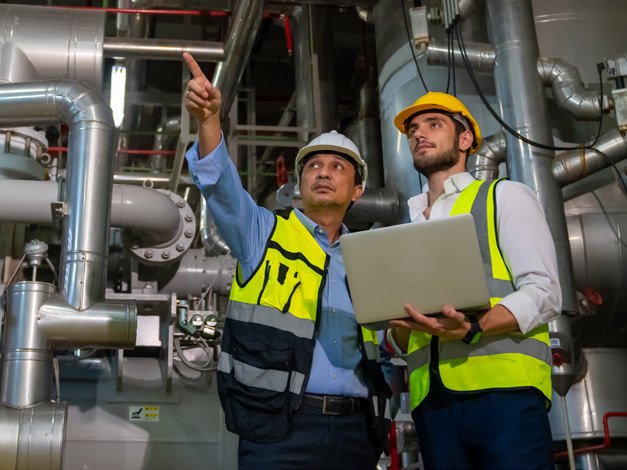 Engineers reviewing plans at a processing plant